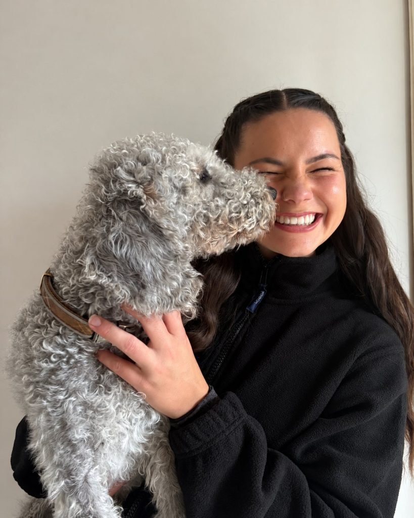 Annabel Webb smiling with a grey dog